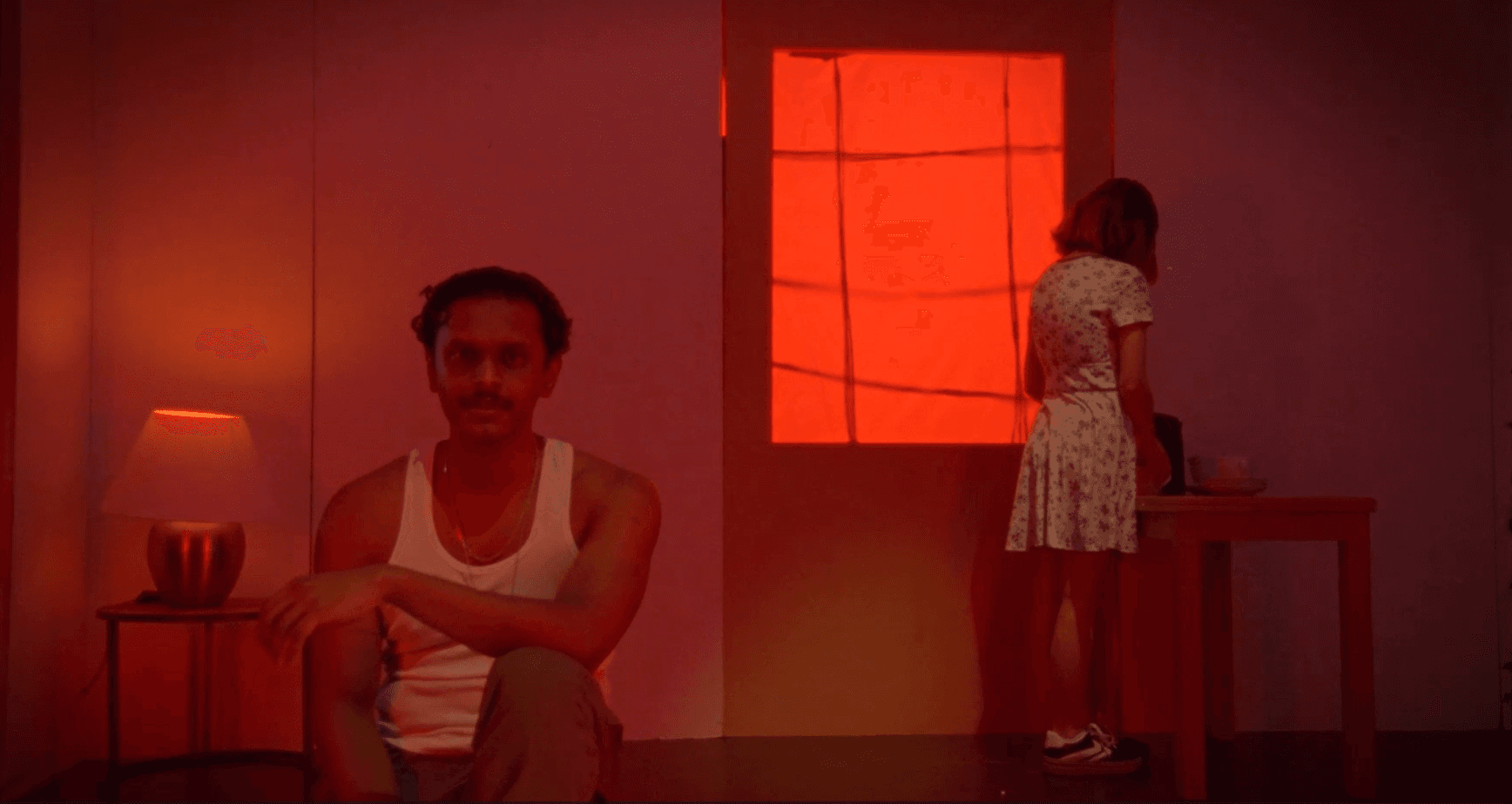 A red-lit scene from Bitter Tea